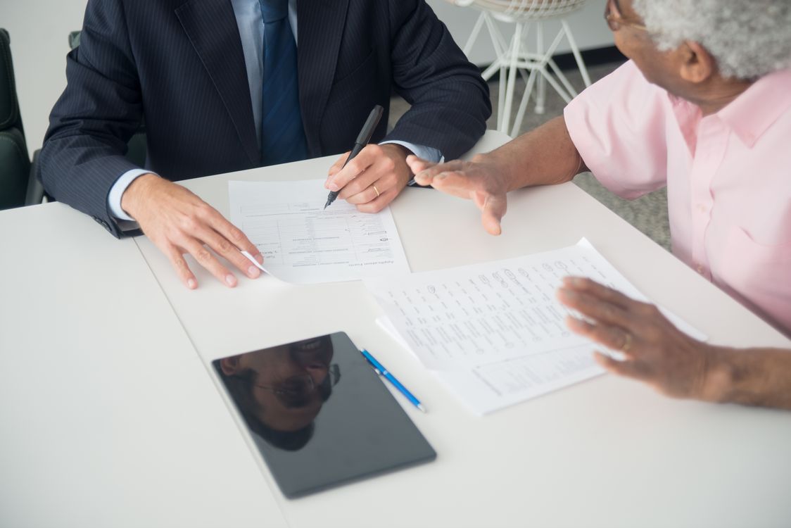 Financial advisor reviewing succession plan documents with a client