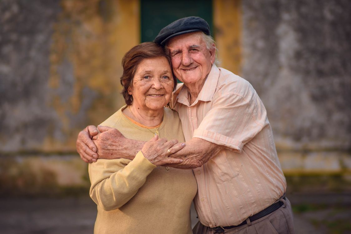 Older couple embracing outdoors, representing lasting love and legacy