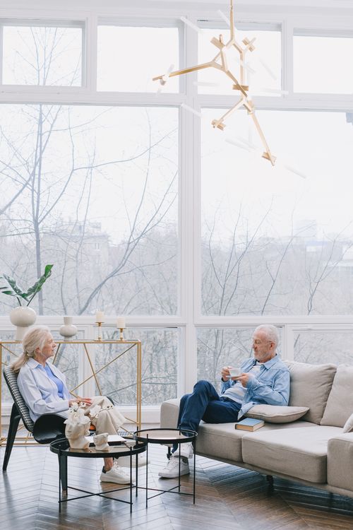 Senior couple relaxing at home, confident in their family's future